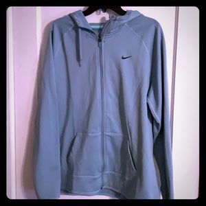 Blue nike athletic jacket.